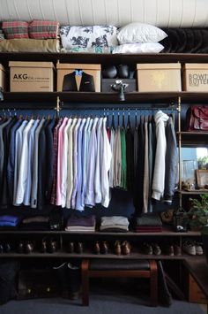 an organized closet with clothes and shoes