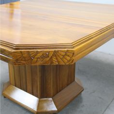 a large wooden table sitting on top of a cement floor