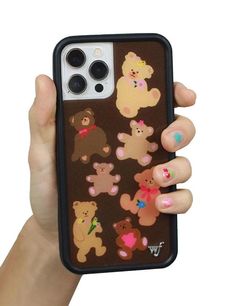 a person holding up a phone case with teddy bears on the front and back cover