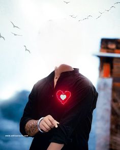 a man holding a red heart in his right hand and birds flying around him on the other side