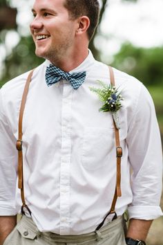 a man wearing suspenders and a bow tie