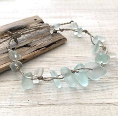 Gorgeous beach bracelet or anklet made with light mint green sea glass pebbles on our durable hand spun rope cord. Pure island style! Easy and secure adjustable slide knot closure allows for easy on and off. This bracelet/anklet is completely waterproof and metal free making it perfect for anyone with skin sensitivities and is a wonderful and unique gift for those hard to shop for friends and family on your list, especially the beach lovers! Color: Mint Green Size: Available in three sizes. Brac Green Beaded Bracelets With Adjustable Cord For Beach, Handmade Adjustable Sea Glass Bracelets, Hand-strung Waxed Cord Beach Bracelets, Hand-strung Waxed Cord Bracelets For Beach, Adjustable Recycled Glass Beaded Bracelets For Beach, 2024 Jewelry, Pale Mint Green, Glass Pebbles, Beach Bracelet