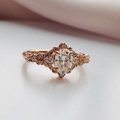 a close up view of an engagement ring on a white surface