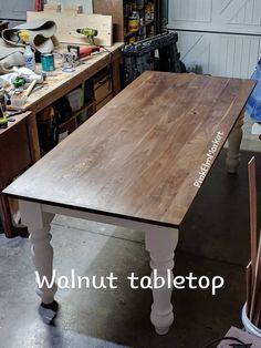 a wooden table sitting inside of a garage