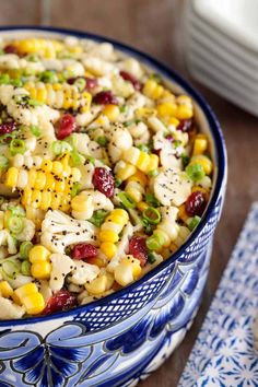 a blue and white bowl filled with corn salad