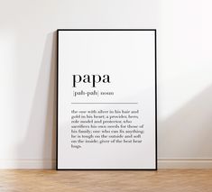 a black and white poster with the words papa on it next to a wooden floor