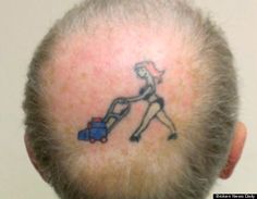 the back of a man's head with a tattoo on his forehead and neck