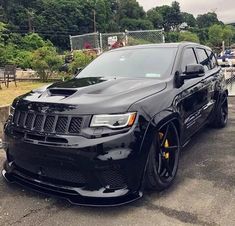 a black jeep parked in a parking lot