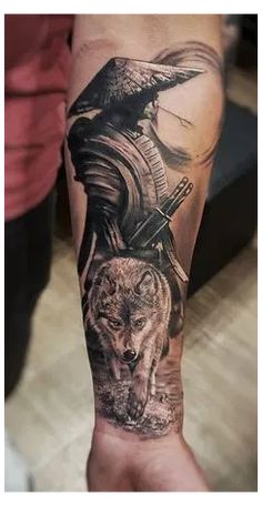 a person with a tattoo on their arm holding a bird and a wolf in the background