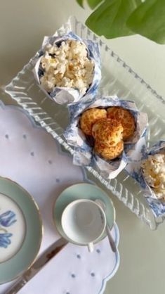 some food is sitting on a tray next to a cup and saucer