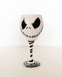 a wine glass decorated with the face of jack skellingy from the nightmare before it's been painted