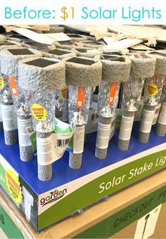 several solar lights are on display in a store for sale with the price tag below them