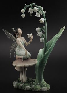 Lily of the Valley figurine showing a fairy with transparent wings on a mushroom, holding a flower and looking up at more lily of the valley blooms Lily Of The Valley Fairy, Fairy Sculpture, Fairy Statues, Lily Of The Valley Flowers, Valley Flowers, Fantasy Gifts, Fairy Pictures, Fairy Figurines, Female Figure