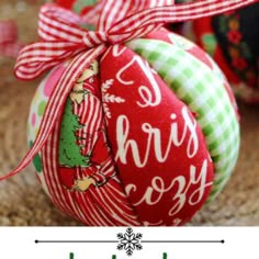 an ornament with the words merry christmas written on it and two decorated ornaments