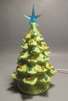 a ceramic christmas tree with blue star on top