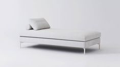 a white chaise lounger with two pillows on it's back and sides