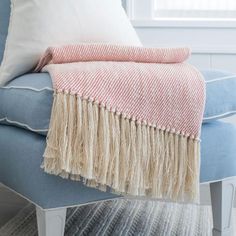 a blue chair with a red and white blanket on it