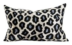 a black and white leopard print pillow on a white background