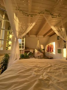 an unmade bed sitting under a white canopy