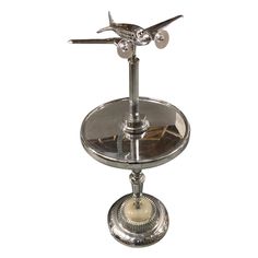 a silver plate with an airplane decoration on it's side and two candles in the middle