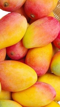 a pile of mangoes sitting on top of each other