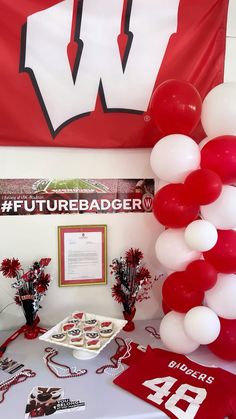 a table topped with red and white balloons