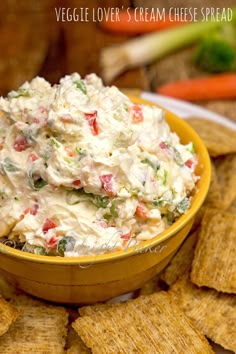 vegetable lover's cream cheese spread in a bowl surrounded by crackers