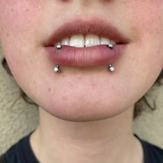 a woman with piercings on her lips