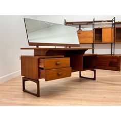 a wooden desk with two drawers and a mirror on top