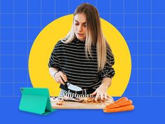 a woman cutting carrots on a board with a knife and fork in front of her