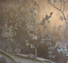 the wall is decorated with flowers and birds