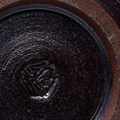 a close up view of a black and brown bowl