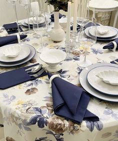 the table is set with blue and white place settings