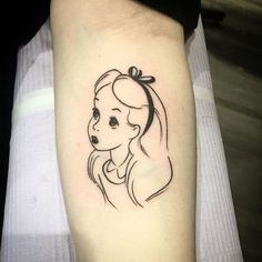 a woman's face with a ponytail tattoo on her arm