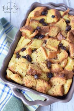 baked bread and raisins in a baking dish on a blue checkered towel