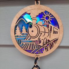 a wooden clock that has a train on it