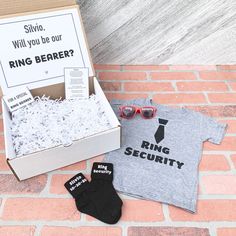 the ring bearer shirt and socks are in a box next to it's packaging