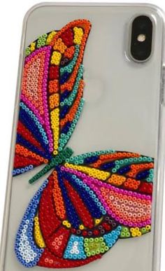 an iphone case with a colorful butterfly on it's back and the phone cover is made out of sequins