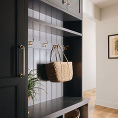 a wooden bench with a basket hanging on it