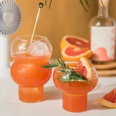 grapefruit and rosemary garnish cocktails on a table