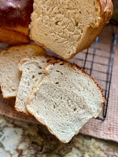 two loaves of bread sitting on top of a cooling rack