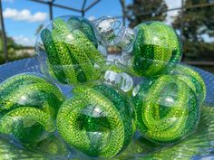 green glass balls sitting on top of a table