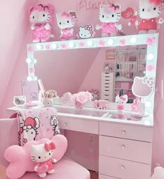 a hello kitty themed bedroom with pink furniture and accessories on the vanity table, along with an illuminated hello kitty mirror