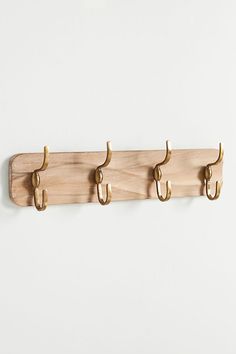 three wooden hooks hang on the wall