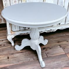 a white table sitting on top of a wooden floor