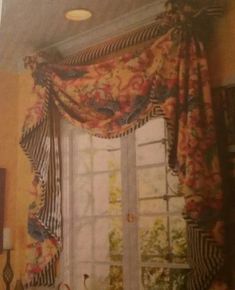 an old photo of a kitchen window with flowers on the valance and curtains hanging over it