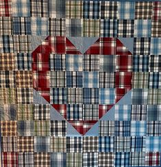 a quilt with a heart made out of plaid fabric on the front and back side