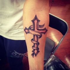 a person with a tattoo on their arm and the words amazing cross tattoo design on them