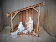 a nativity scene with two people and a baby jesus