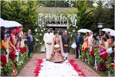 a bride and groom are walking down the aisle